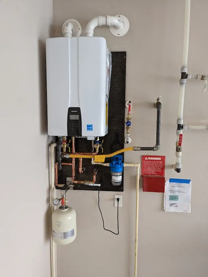 Professional plumber installing copper piping in a Marin City home